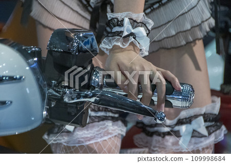 A woman's hand on the handlebar of a motorcycle A woman's hand on the handlebar of a motorcycle 109998684