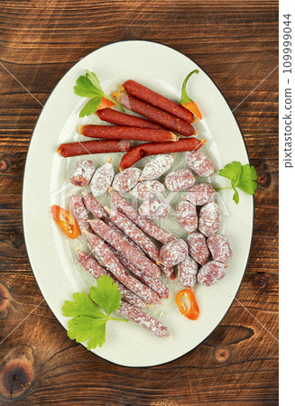 Tasty salami on a plate Tasty salami on a plate 109999044