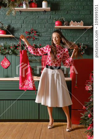 Lovely woman in festive attire preparing for Christmas 109999351
