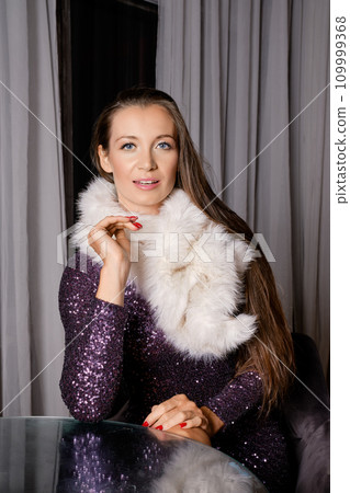 Elegant woman in sequin dress and fur collar 109999368