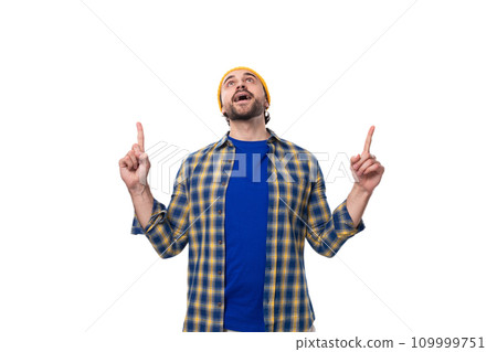 young caucasian brunette handsome man with a beard and mustache points his hand to the side on a 109999751