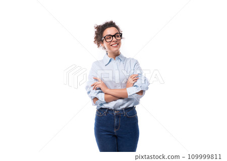 portrait of a young smart brunette lady assistant dressed in a basic blue shirt and jeans portrait of a young smart brunette lady assistant dressed in a basic blue shirt and jeans 109999811