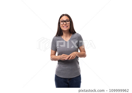 young smiling cute brunette european woman dressed in a gray t-shirt with a mockup on a white young smiling cute brunette european woman dressed in a gray t-shirt with a mockup on a white 109999962