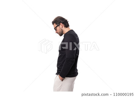 a young brunette man with a black beard and mustache dressed in a black turtleneck stands in profile a young brunette man with a black beard and mustache dressed in a black turtleneck stands in profile 110000195