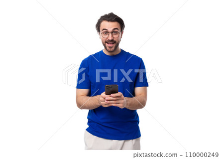 A 30 year old European brutal guy with black hair and a beard uses a mobile phone 110000249