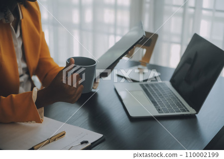 Creative Asian young woman working on laptop in her studio Creative Asian young woman working on laptop in her studio 110002199