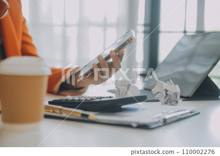 Portrait of tired young business Asian woman work with documents tax laptop computer in office. Sad, unhappy, Worried, Depression, or employee life stress concept Portrait of tired young business Asian woman work with documents tax laptop computer in office. Sad, unhappy, Worried, Depression, or employee life stress concept 110002276