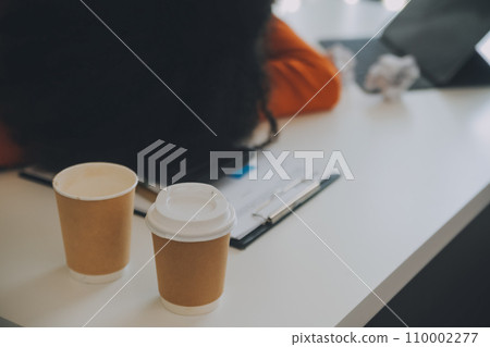 Portrait of tired young business Asian woman work with documents tax laptop computer in office. Sad, unhappy, Worried, Depression, or employee life stress concept Portrait of tired young business Asian woman work with documents tax laptop computer in office. Sad, unhappy, Worried, Depression, or employee life stress concept 110002277