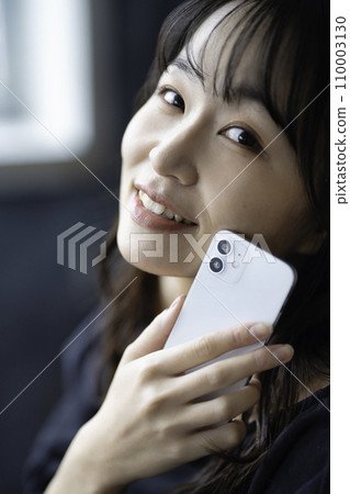 A young woman using a smartphone 110003130