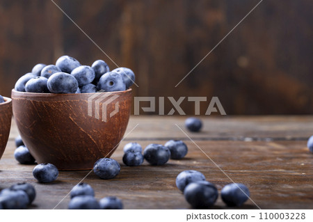 Freshly picked blueberries in  bowl. Bilberry on wooden Background.  110003228