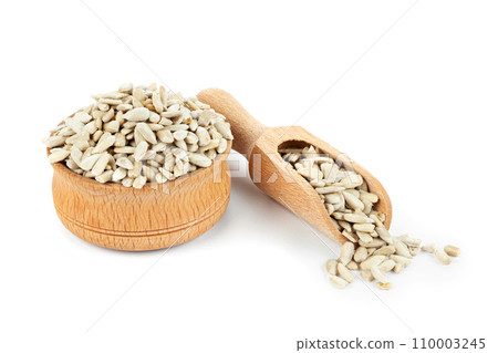 Hulled sunflower seeds in wooden bowl isolated on white background 110003245