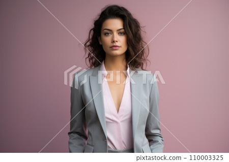 Model in a pastel-toned suit, standing confidently with hands on hips, her shadow mirroring her stance on the minimalist background Model in a pastel-toned suit, standing confidently with hands on hips, her shadow mirroring her stance on the minimalist background 110003325