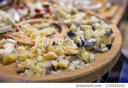 various cheeses for tasting on a wooden plate various cheeses for tasting on a wooden plate 110004262