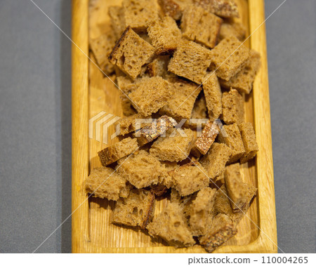 Rye bread crackers on a wooden plate 110004265