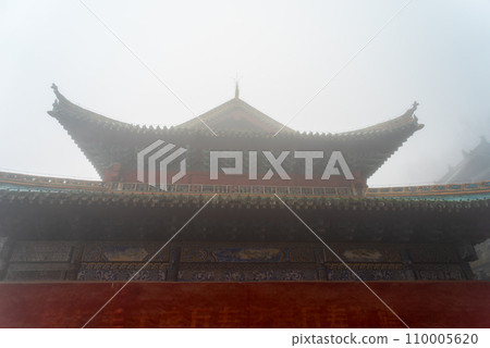 The mysterious ancient building complex of Wudang Mountain in the fog. The mysterious ancient building complex of Wudang Mountain in the fog. 110005620