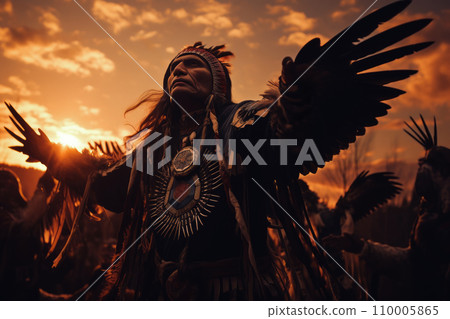 Native American dancers performing a ceremonial eagle dance at sunset. 110005865