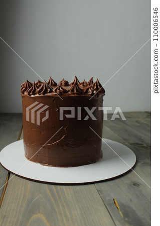 Chocolate Fresh Cake on Stand on Grey Background Homemade Pastry Chef. Artisan food 110006546