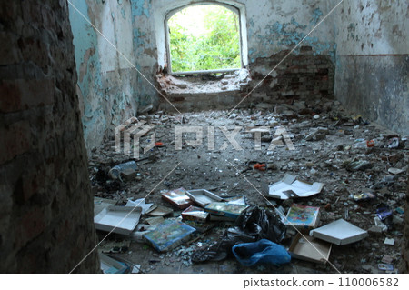 An abandoned ruined room with fragments of a wall of bricks. The aftermath of the war, the bombing. decadence 110006582