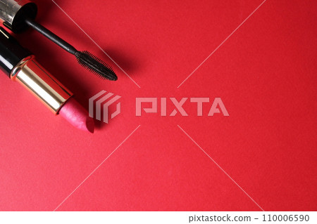 Make-up lipstick and mascara on a red background with space for text and copy space. Beauty salon home salon shopping for women how to choose lipstick color types types of makeup 110006590