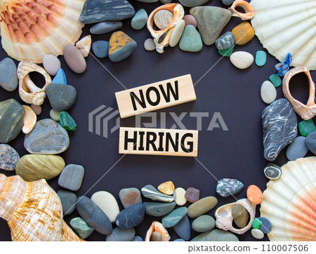 Now hiring symbol. Concept words Now hiring on beautiful wooden block. Beautiful black table black background. Sea stone sea shell. Business marketing, motivational now hiring concept. Copy space. 110007506