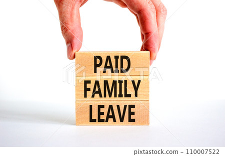 Paid family leave symbol. Concept words Paid family leave on wooden blocks. Doctor hand. Beautiful white table white background. Business medical and paid family leave concept. Copy space. Paid family leave symbol. Concept words Paid family leave on wooden blocks. Doctor hand. Beautiful white table white background. Business medical and paid family leave concept. Copy space. 110007522
