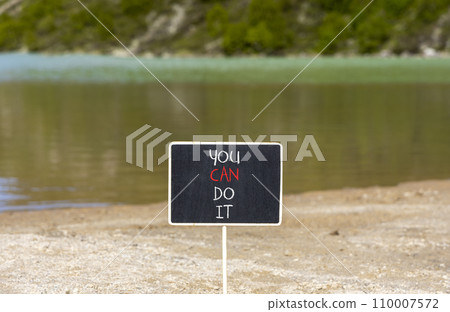 You can do it symbol. Concept word You can do it on beautiful black chalk blackboard. Beautiful mountain lake background. Business motivational you can do it concept. Copy space. 110007572
