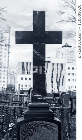 Stone cross at cemetery. Religious symbol over tombstone Stone cross at cemetery. Religious symbol over tombstone 110008020