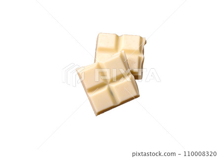 Delicious sweet white chocolate broken into cubes on a wooden cutting board 110008320
