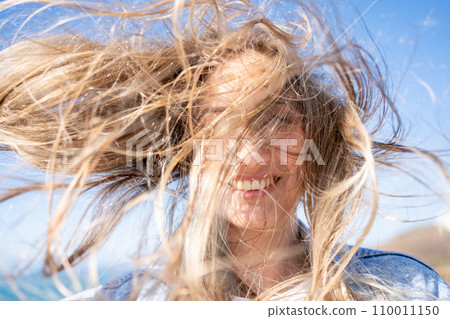 Closeup of young woman face covered with flying Closeup of young woman face covered with flying 110011150