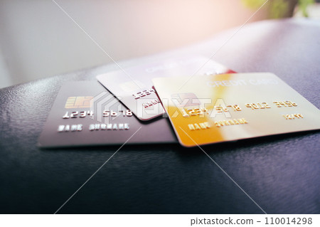 Credit or debit cards on leather table with a sunlight , selective focus 110014298