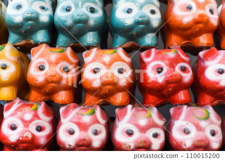 Many similar colorful piggy bank in row 110015200