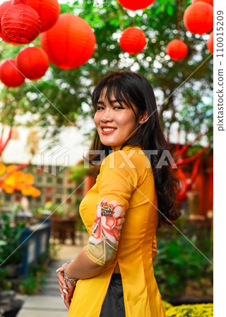 Beautiful Vietnamese woman in traditional vietnamese dress near red lanterns in Tet  Lunar New Year 110015209