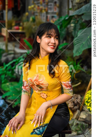 Beautiful Vietnamese woman in traditional vietnamese dress in Tet Lunar New Year Beautiful Vietnamese woman in traditional vietnamese dress in Tet Lunar New Year 110015219
