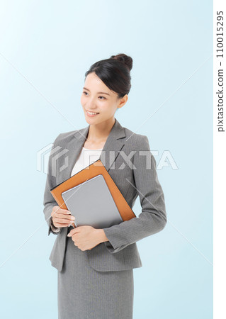 Smiling business woman standing 110015295