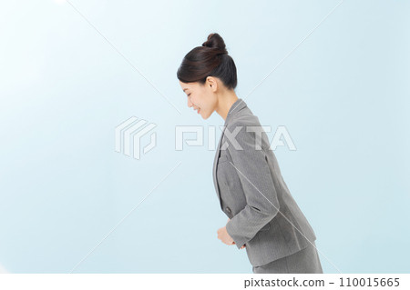 A woman in a suit about to bow A woman in a suit about to bow 110015665