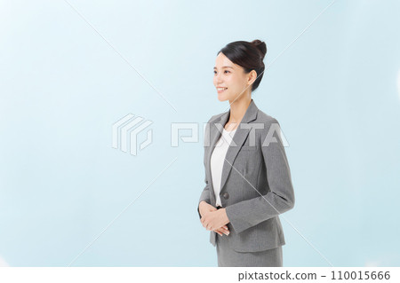 A woman in a suit about to bow A woman in a suit about to bow 110015666
