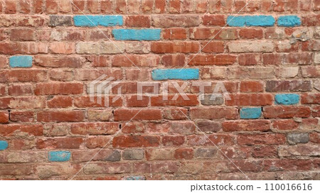 old red brick wall with splashes of blue blocks as a background texture for design, textured brickwork backdrop with empty copy space, graphic resource of the relief surface 110016616