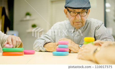 Senior man looking straight with serious look in a geriatrics Senior man looking straight with serious look in a geriatrics 110017375