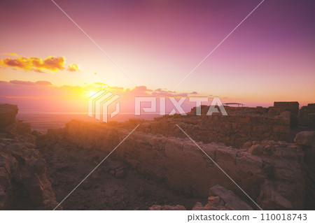 Beautiful purple sunrise over Masada fortress. Ruins of King Herod's palace in the Judaean Desert 110018743