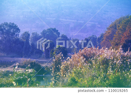 Mountain landscape in the evening. Beautiful lake against mountains. The Hula Valley in northern Israel at sunset 110019265