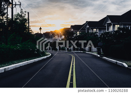 Modern cottages row road sidewalk two story buildings residential villas village New Estate Reflection dawn Sun in windows Modern cottages row road sidewalk two story buildings residential villas village New Estate Reflection dawn Sun in windows 110020288