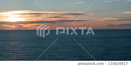 Serene Sunset Over Calm Ocean Waters Captured Beautifully 110020617