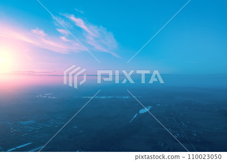 Rural landscape in the morning with the blue-pink sky. Aerial view of the countryside during sunrise Rural landscape in the morning with the blue-pink sky. Aerial view of the countryside during sunrise 110023050