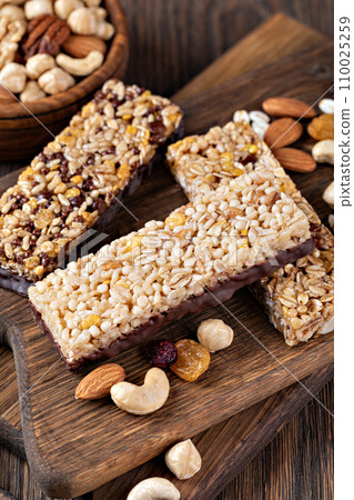 Granola bar on wooden background 110025259