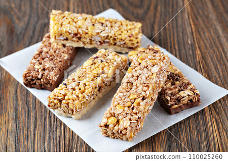Granola bar on wooden background 110025260