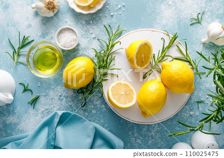 Lemon, rosemary, garlic, salt and olive oil. Ingredients for mediterranean cuisine cooking. Top view 110025475