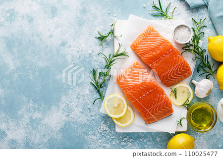 Salmon. Fresh raw salmon fish fillet with cooking ingredients, herbs and lemon, top view Salmon. Fresh raw salmon fish fillet with cooking ingredients, herbs and lemon, top view 110025477