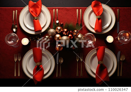 Christmas table setting with dishware, silverware and decorations on festive table. Christmas table setting with dishware, silverware and decorations on festive table. 110026347