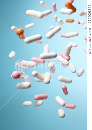 flying pill tablet capsule on blue background. levitation medicine. 110026361