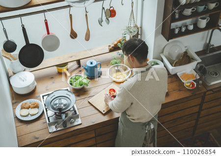 Overhead view of a man in his 30s cooking in the kitchen Overhead view of a man in his 30s cooking in the kitchen 110026854